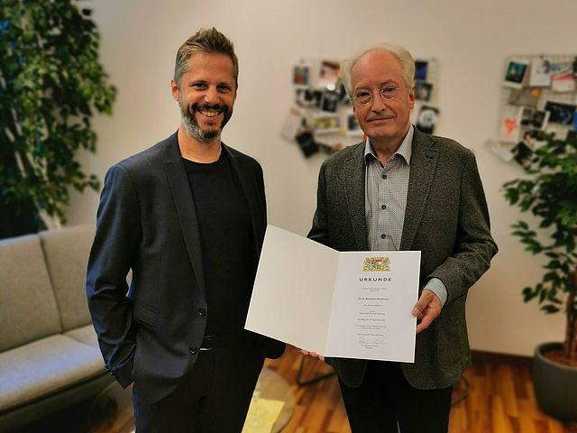 Hochschulpräsident Prof. Rainer Kotzian und Honorarprofessor Bernhard Buttmann mit Ernennungs-Urkunde. 